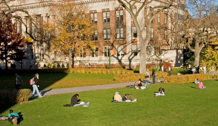 Young people on a lawn on a college campus