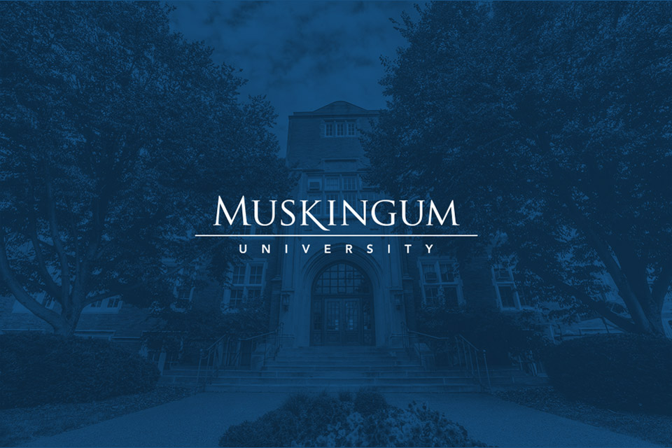 Muskingum University white logo on dark blue overlay of campus photo
