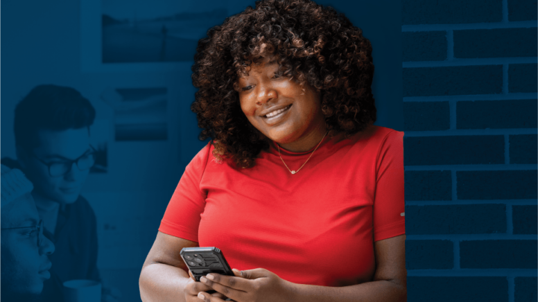 Woman in red shirt with smart phone on blue background